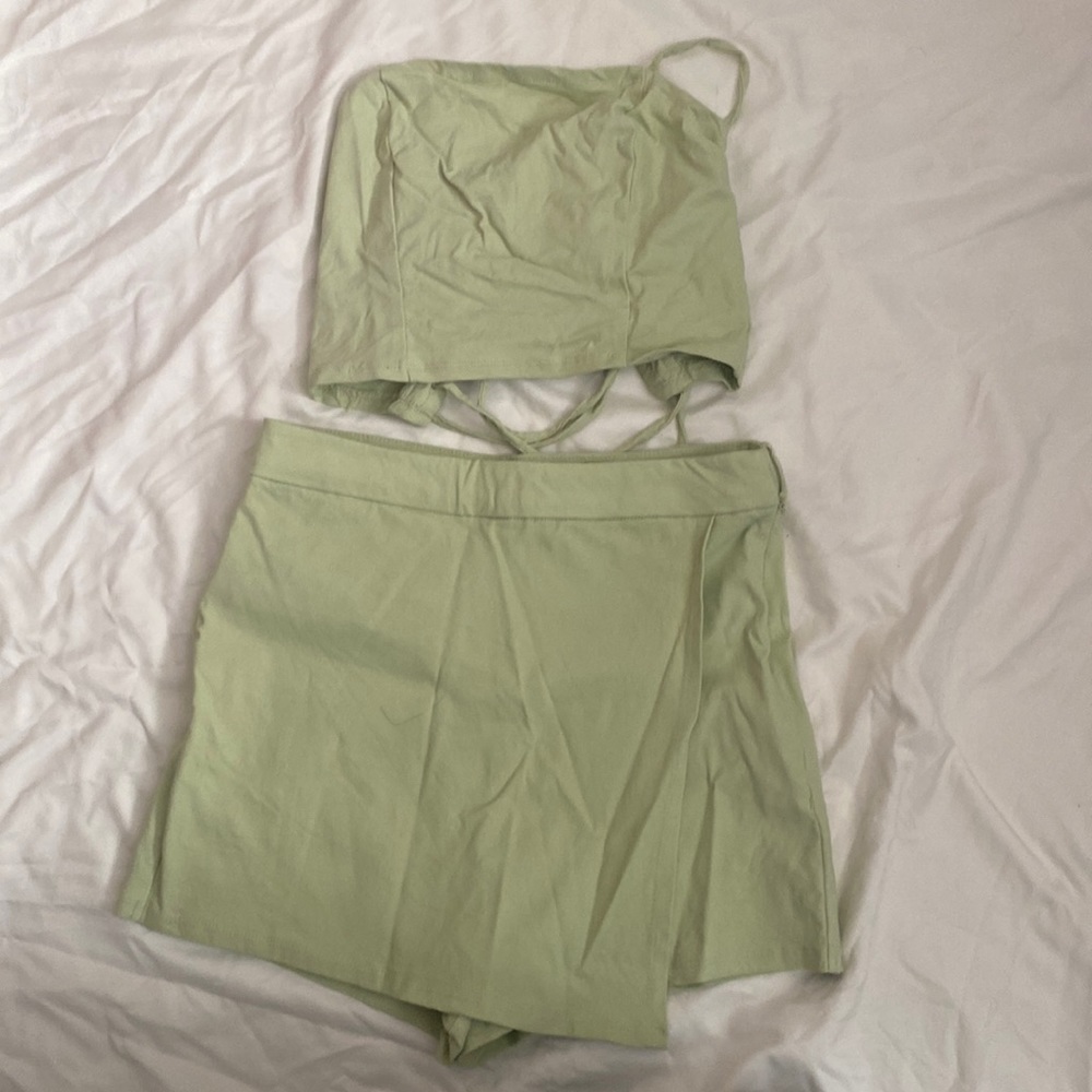 Two piece set. Crop top shirt with very cute tie back, bottom skort.